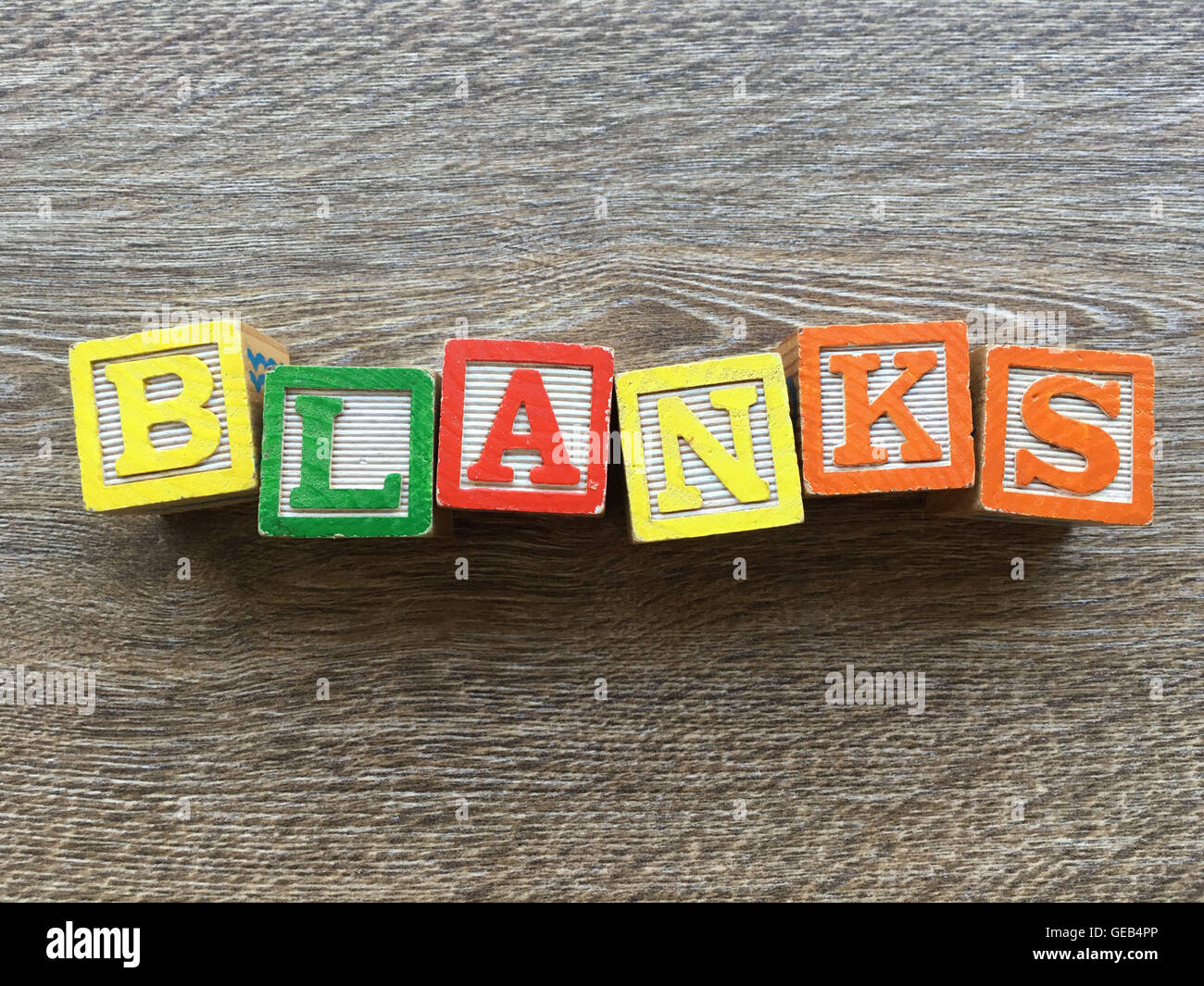 Alphabet wood block letters forming the word BLANKS, combining those