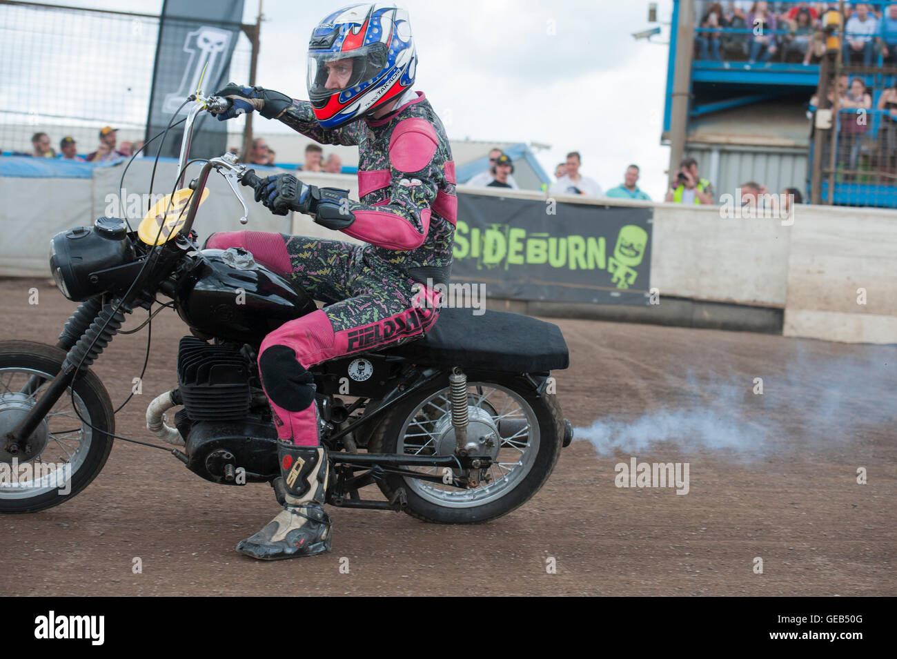Kings Lynn, Norfolk, United Kingdom. 16.07.2016. Fifth annual Dirt Quake festival with Guy Martin and Carl 'Foggy' Fogarty. A man races in retro pink leathers. Stock Photo