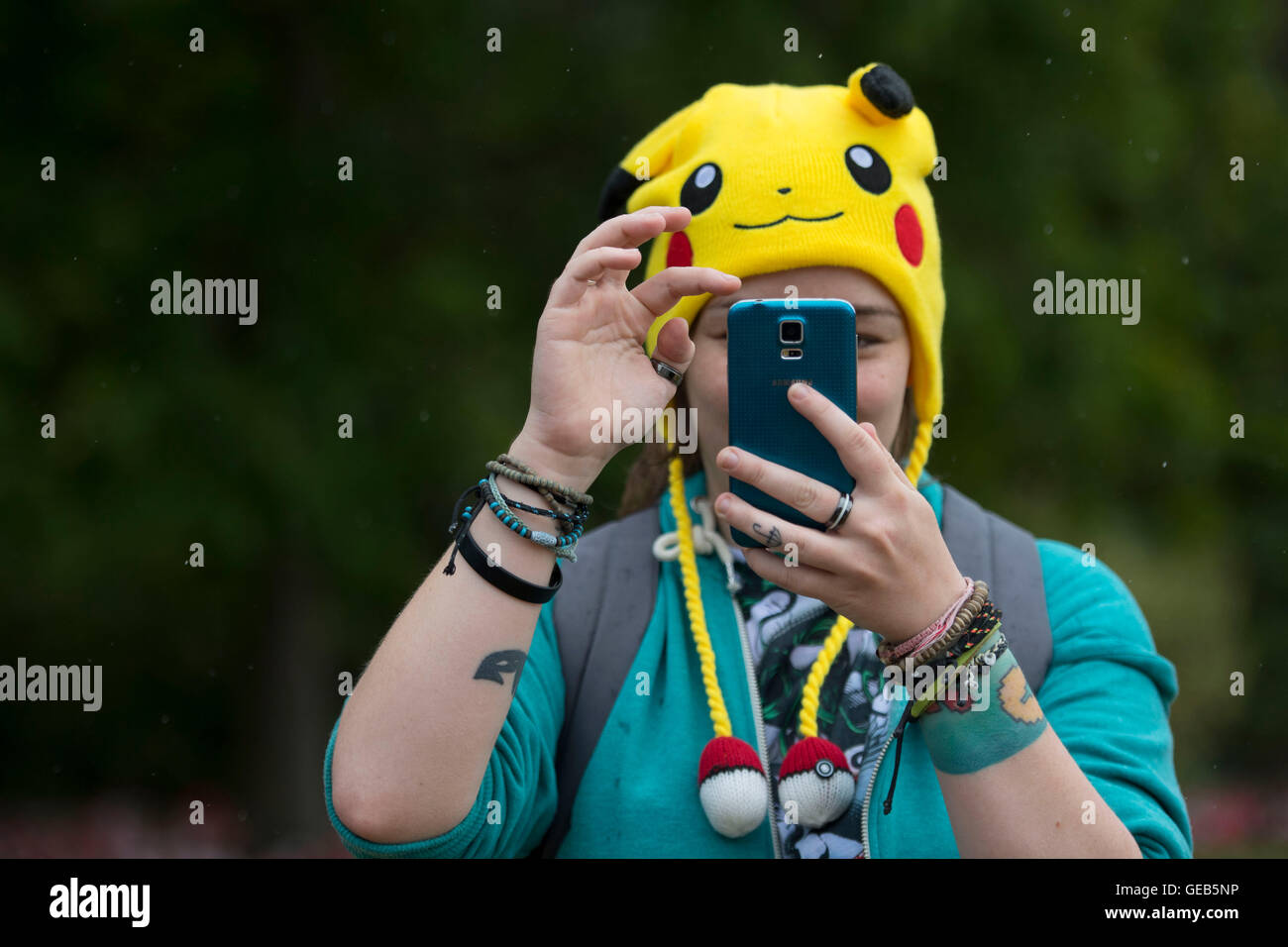 Woman sitting in a car and playing a Pokemon Go game Stock Photo - Alamy