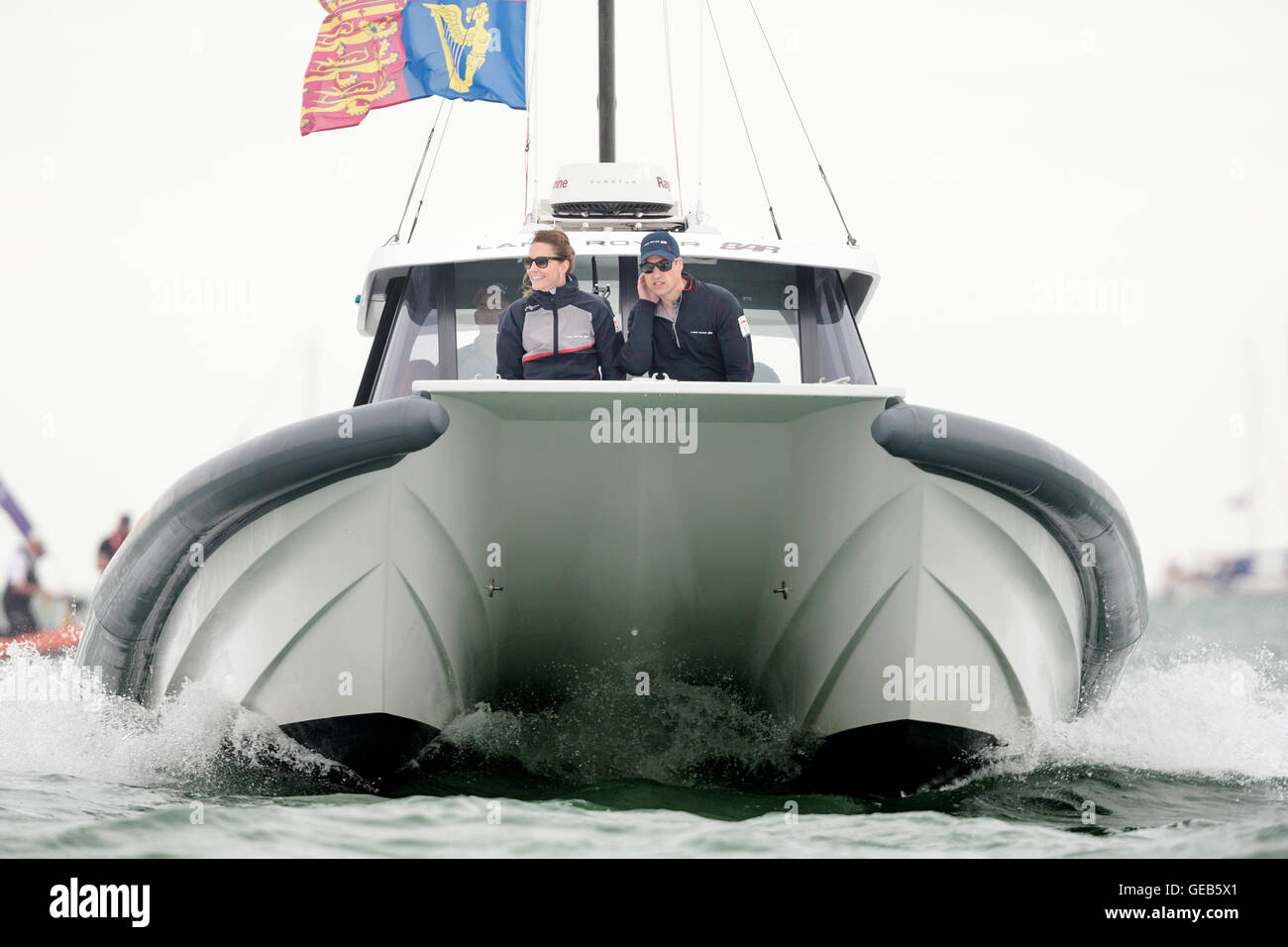 The Duke and Duchess of Cambridge watch Sir Ben Ainslie's Land Rover BAR team racing from a chase boat during day four of the America's Cup World Series Portsmouth event. Stock Photo