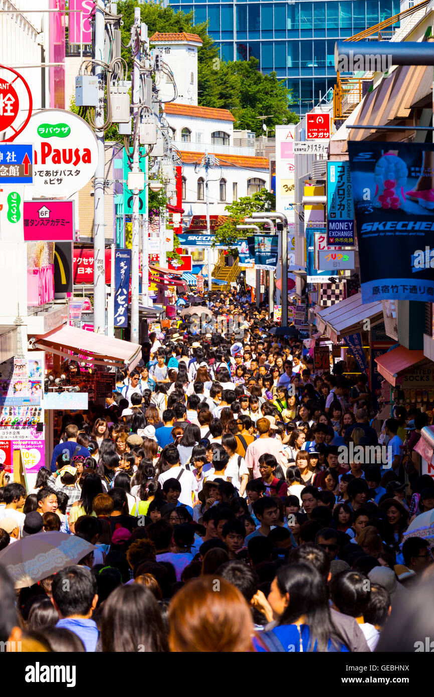 Takeshita street lined with shops and crowded with young teenagers shopping, browsing and hanging out during the day in Harajuku Stock Photo