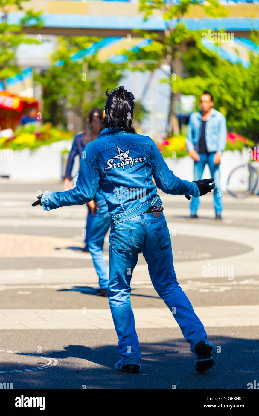Rear of rockabilly dancing man in full jean outfit and slicked back hair performs to 50s rock and roll music weekly at Yoyogi pa Stock Photo