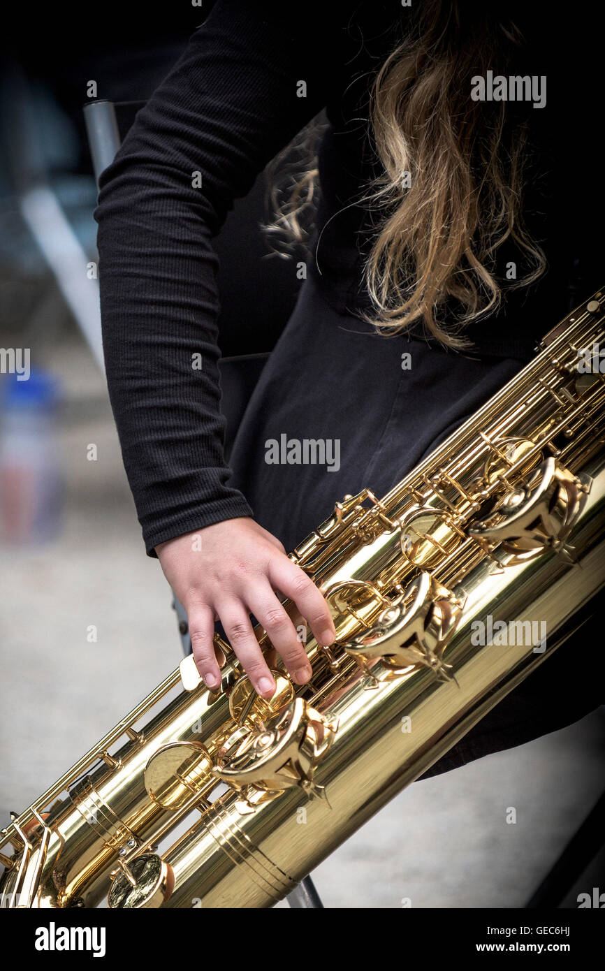 A saxophone player in a jazz band performs at Trebah Gardens amphitheatre in Cornwall. Stock Photo