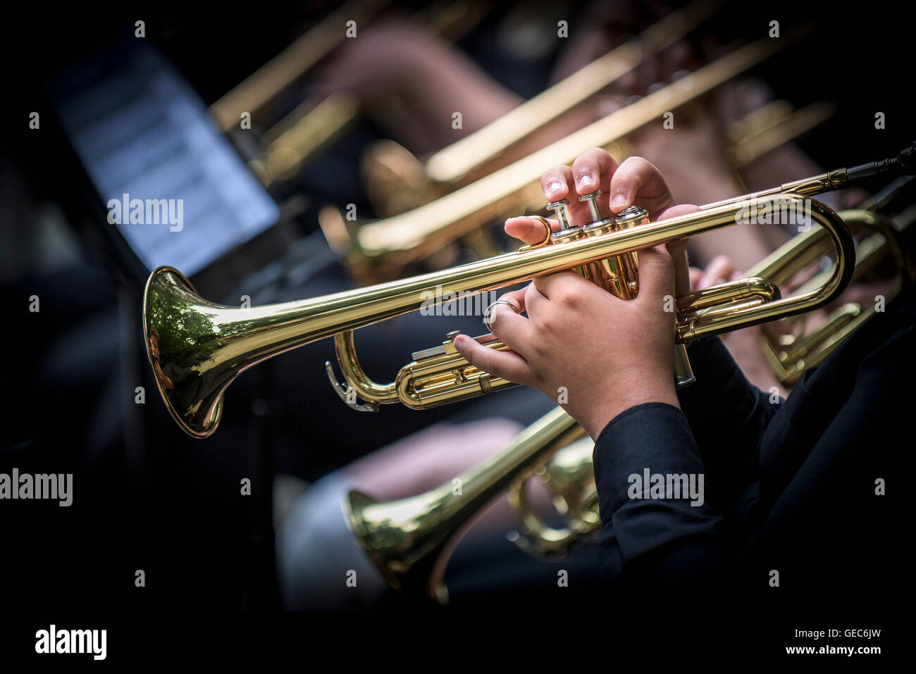 Trumpet players in a jazz band perform at Trebah Gardens amphitheatre in Cornwall. Stock Photo