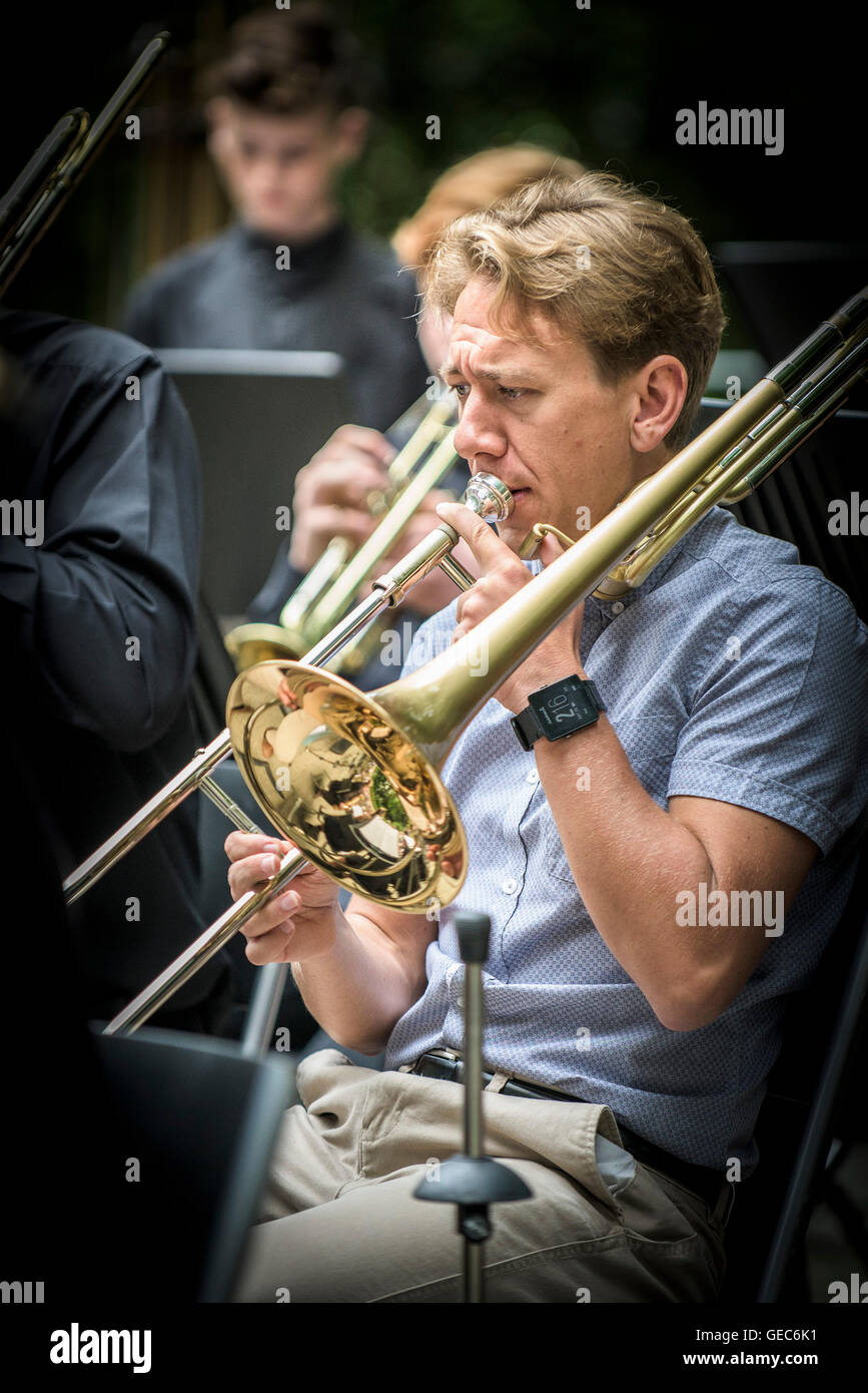A trombonist in a jazz band performs at Trebah Gardens amphitheatre in Cornwall. Stock Photo