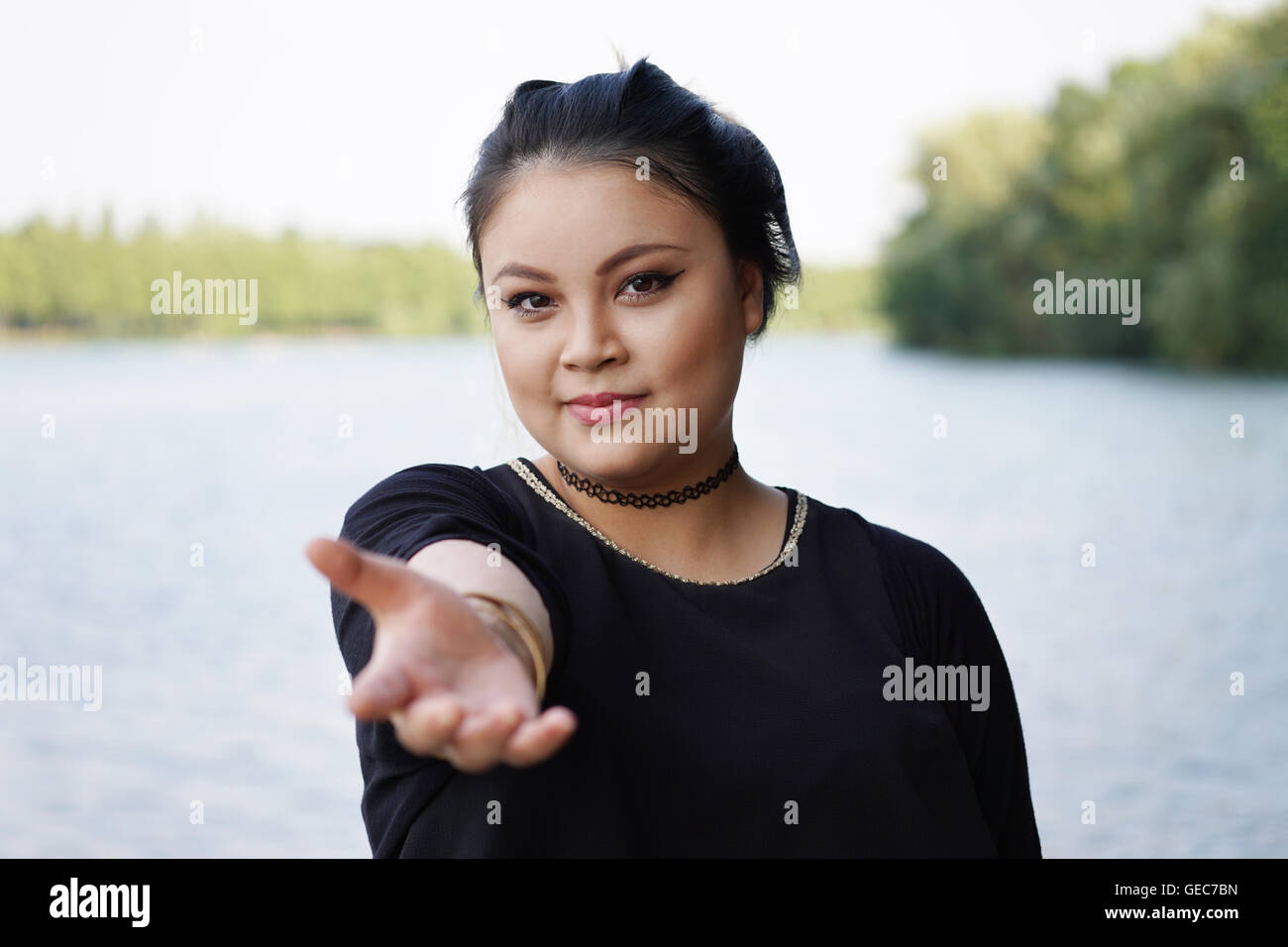 young asian woman reaching out Stock Photo