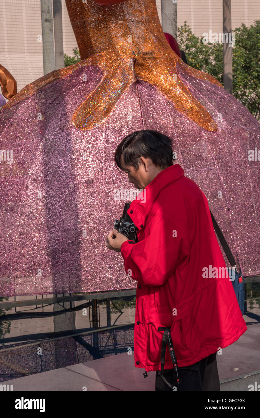 A photographer using a vintage Rollieflex twin lens reflex 120 roll film camera Stock Photo
