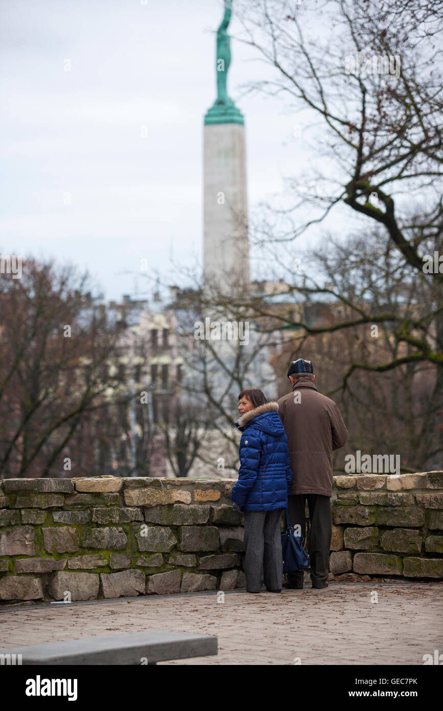 An old couple view from Bastion hill the freedom monument in the center of Riga, and is an important symbol to Latvians Stock Photo