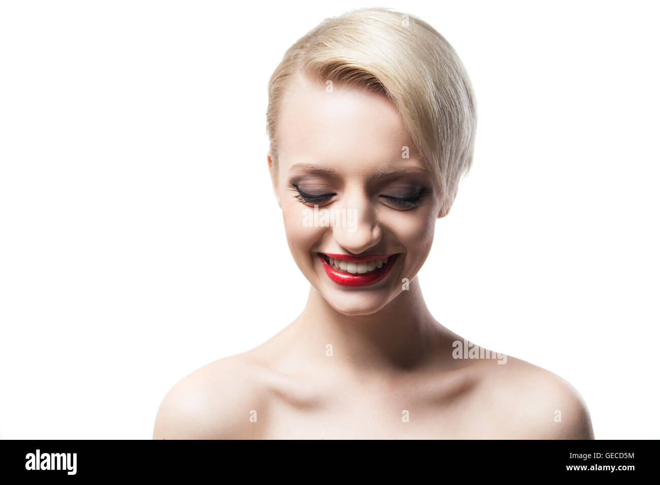 cheerful blonde model with red lips smiling down Stock Photo