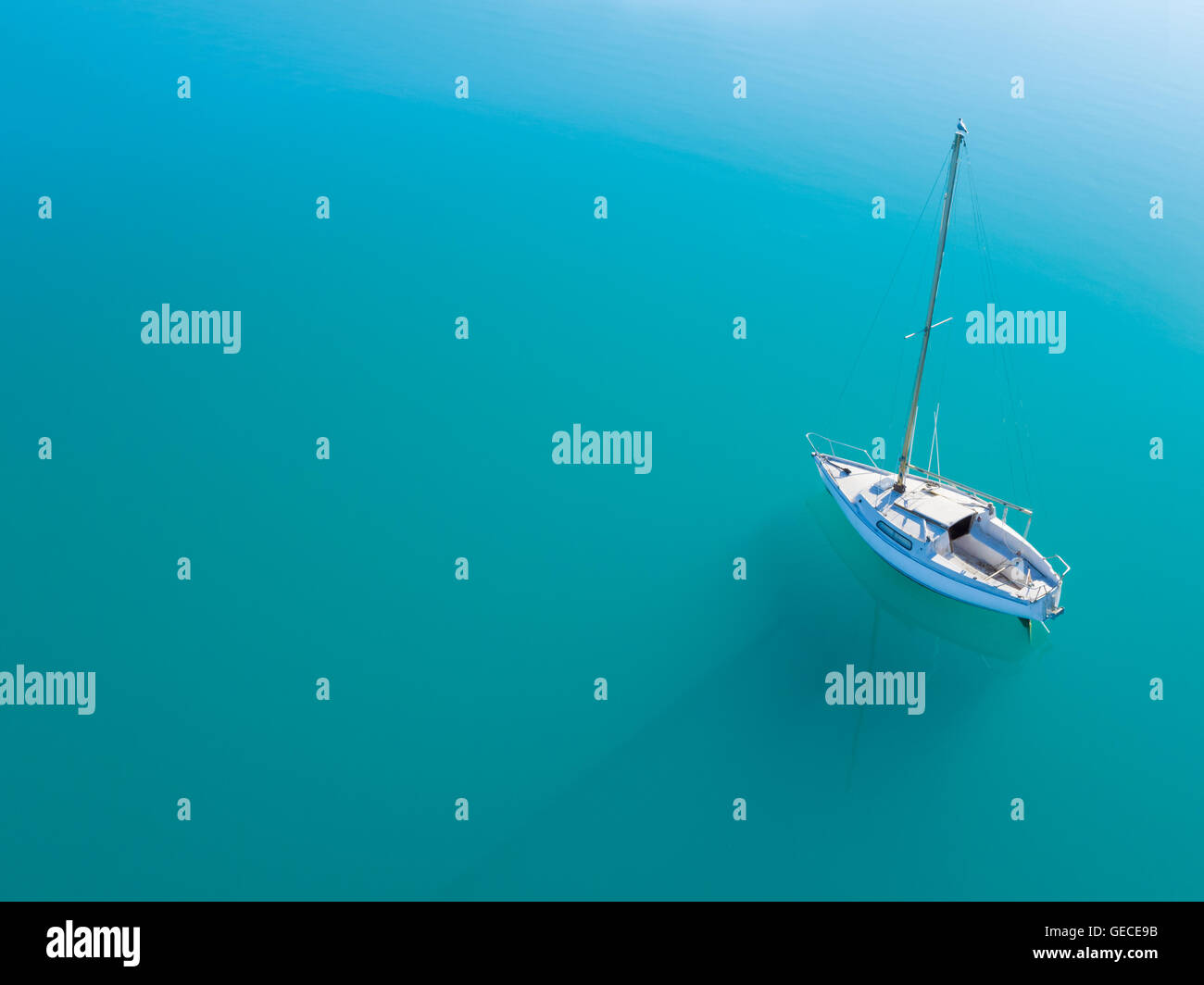 Beautiful aerial view of alone yacht sailling on azure water Stock Photo