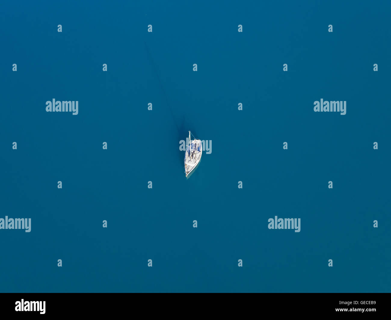 Beautiful aerial view of alone yacht sailling on azure water Stock Photo