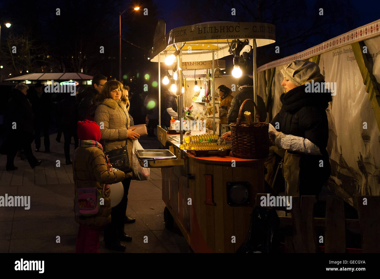 Buying food at Kaziuko mugė or Saint Casimir's Fair an annual festival in November in Lithuanian city of Vilnius. Stock Photo