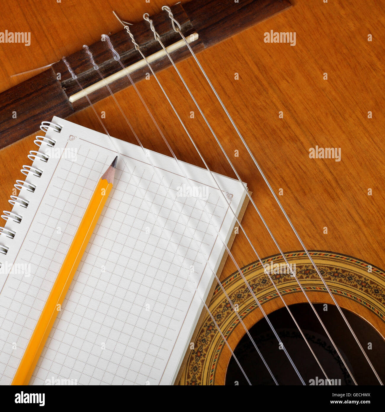 Notebook Design With Instrument Musical instruments - the Acoustic guitar and a notebook with a pencil ...