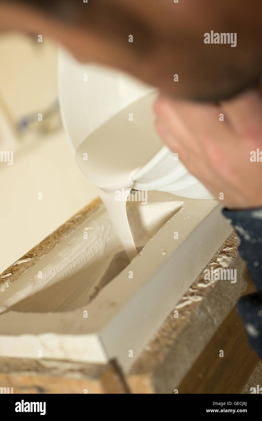 Closeup of liquid plaster being poured into mold Stock Photo Alamy