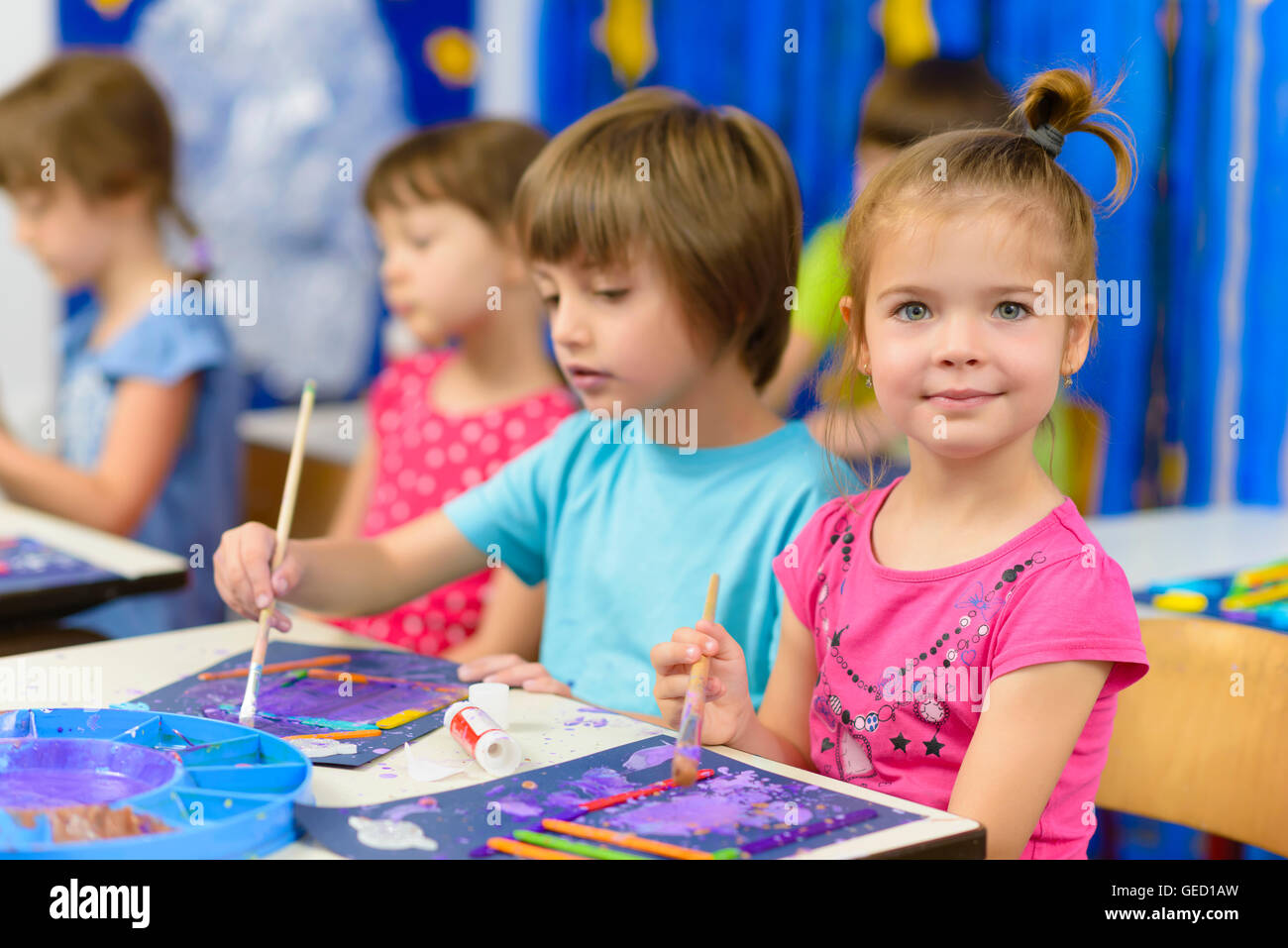 Cute kids doing their craft, painting at kindergarten Stock Photo