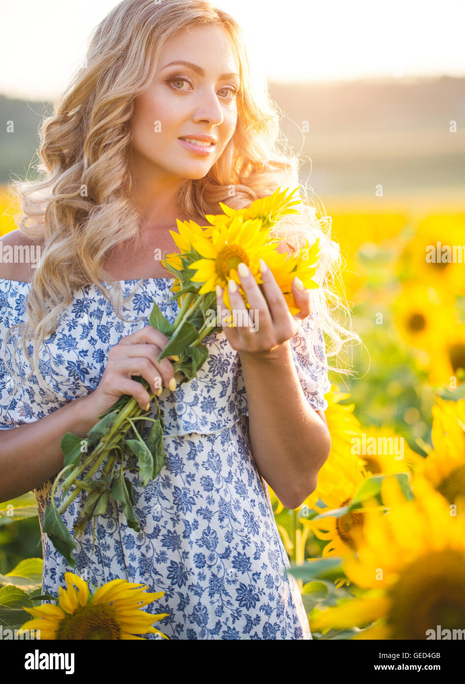 Portrait of the beautiful girl with a sunflowers Stock Photo - Alamy