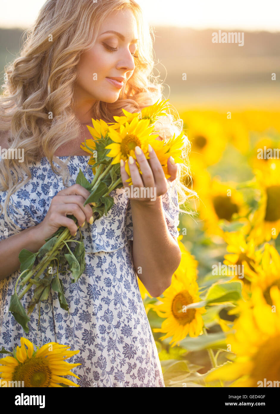 Portrait of the beautiful girl with a sunflowers Stock Photo - Alamy