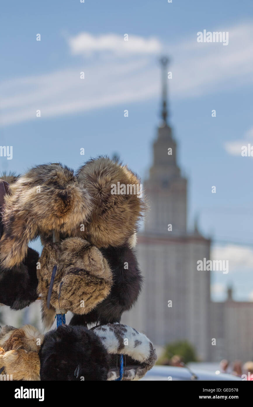 Fur hats, souvenir for tourists on the background of the Moscow State University, Moscow, Russia. Stock Photo