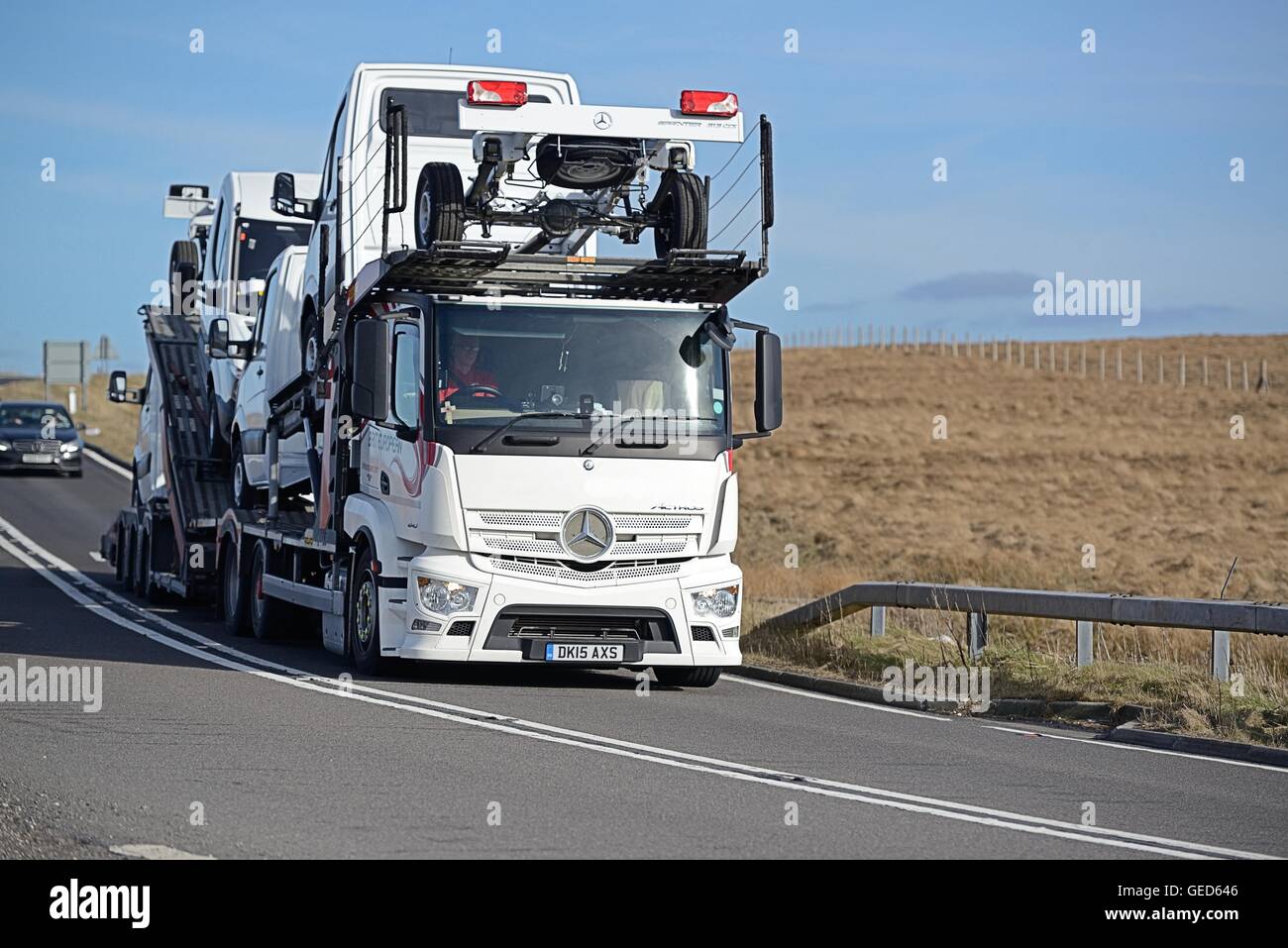 Mercedes-Benz transporter and trailer carrying vans across the A628  Woodhead Pass Stock Photo - Alamy