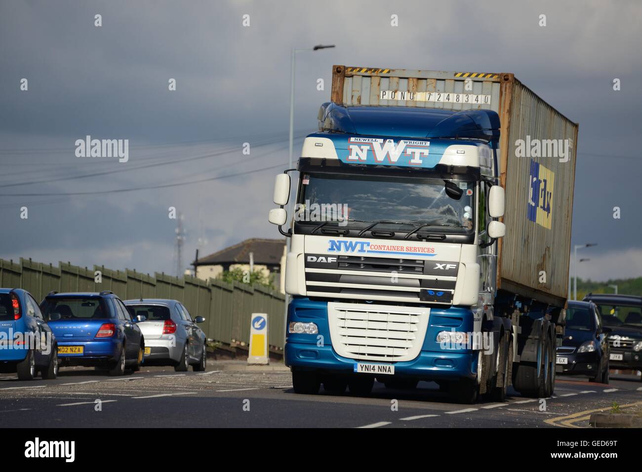 A MAN truck from the freight company Newell and Wright pcarrying a Maersk container driving along a busy main road in Sheffield Stock Photo