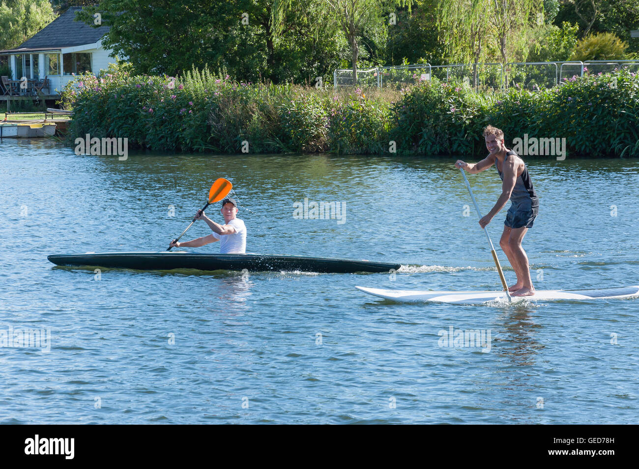 Men on Stand up paddle board and kayak on River Thames, Shepperton, Surrey, England, United Kingdom Stock Photo