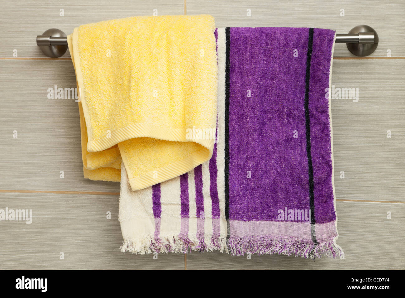 purple and yellow towels in the bathroom Stock Photo - Alamy