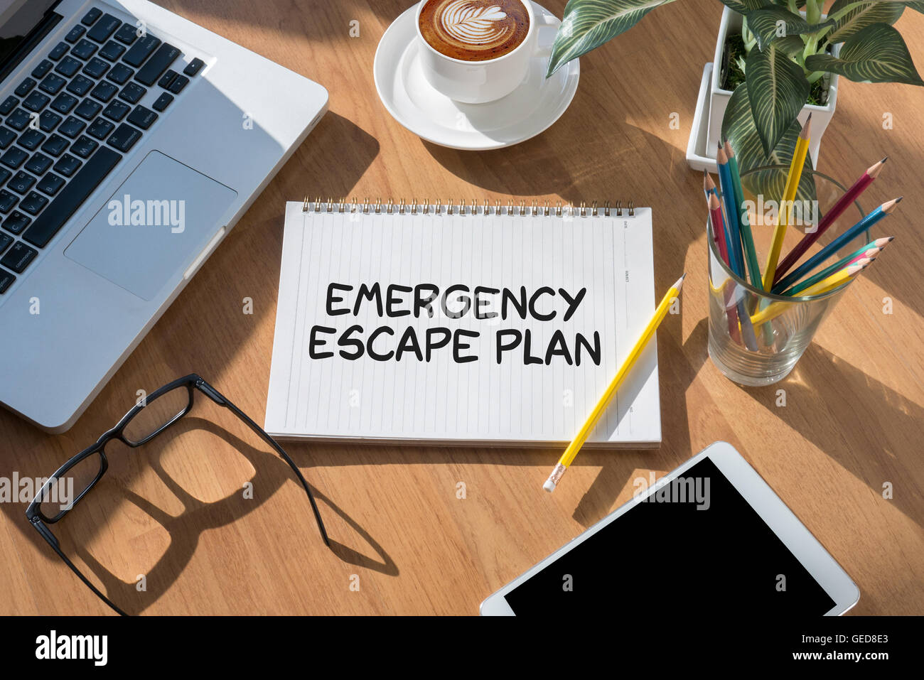 Emergency Escape Plan open book on table and coffee Business Stock Photo