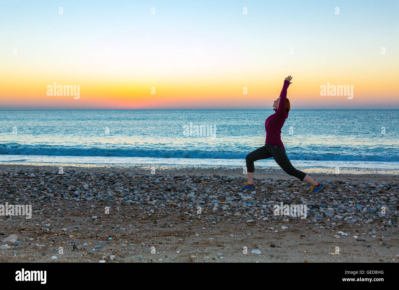 Silhouette of a woman doing yoga on the beach hi-res stock photography ...