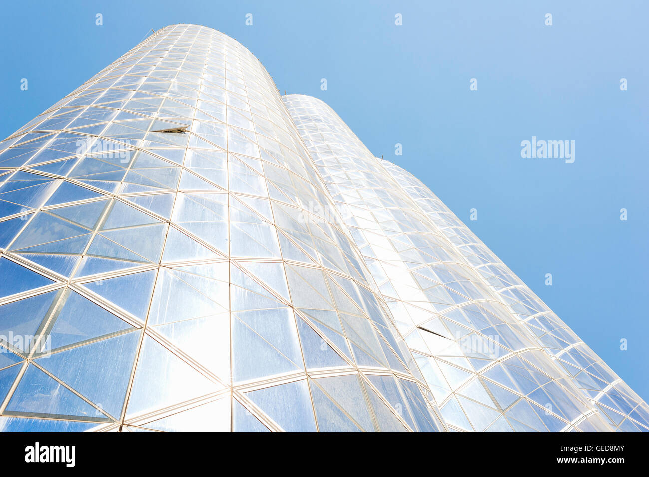 Facades of skyscrapers in Dubai with the blue glass exterior in bright sunlight. Stock Photo