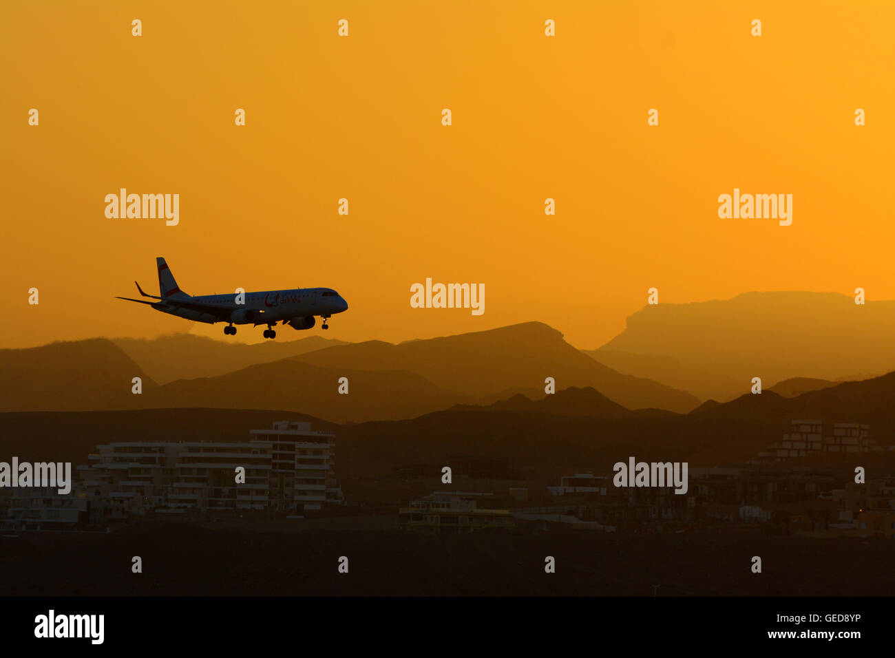 Passenger airplane lands in Eilat at sunset, Israel Stock Photo