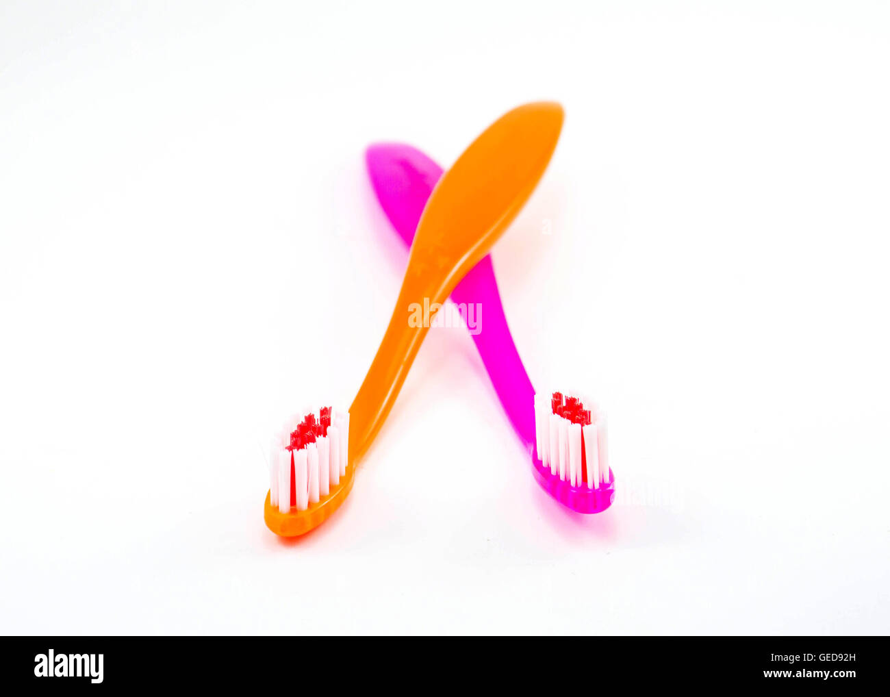 two Toothbrushes colorful on a white background Stock Photo - Alamy