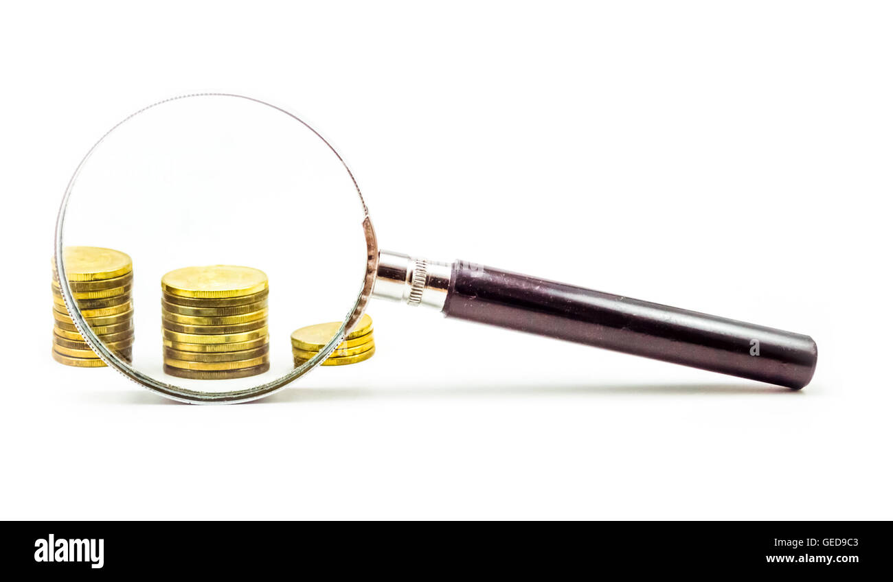 Gold Coins behind magnifying glass in white background Stock Photo - Alamy