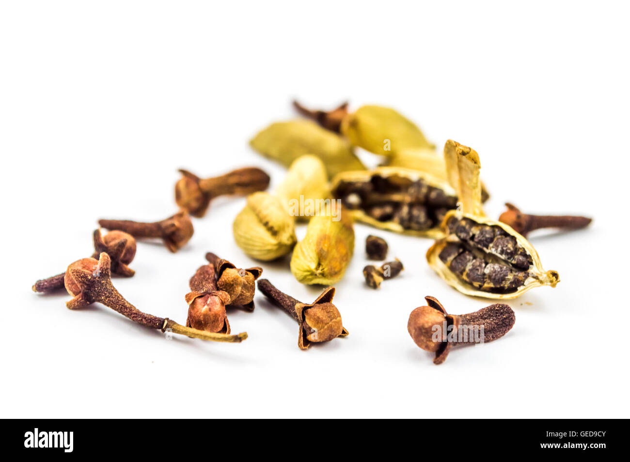 Cloves and Cardamom on white Stock Photo