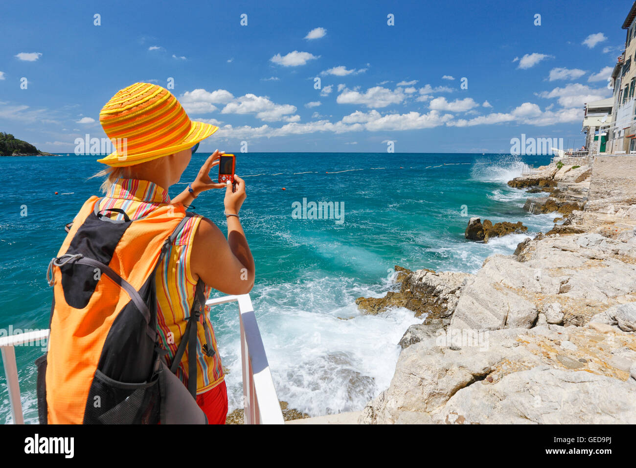 Tourist taking photographing waves in Rovinj old town Stock Photo