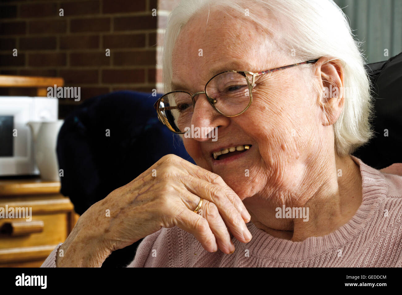 Happy smiling elderly lady in an old-age home Stock Photo