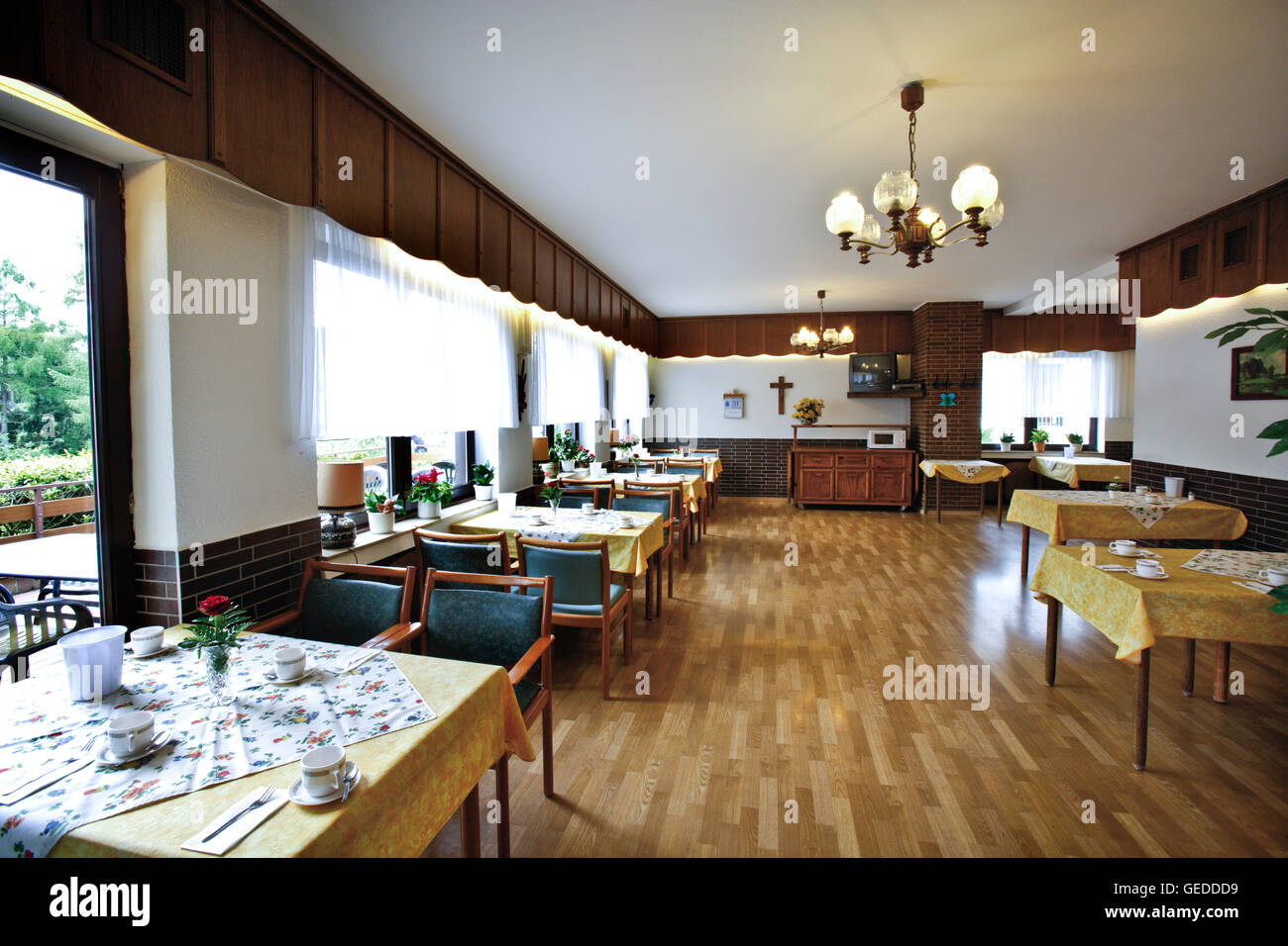 Set tables in the dining hall of a nursing home Stock Photo