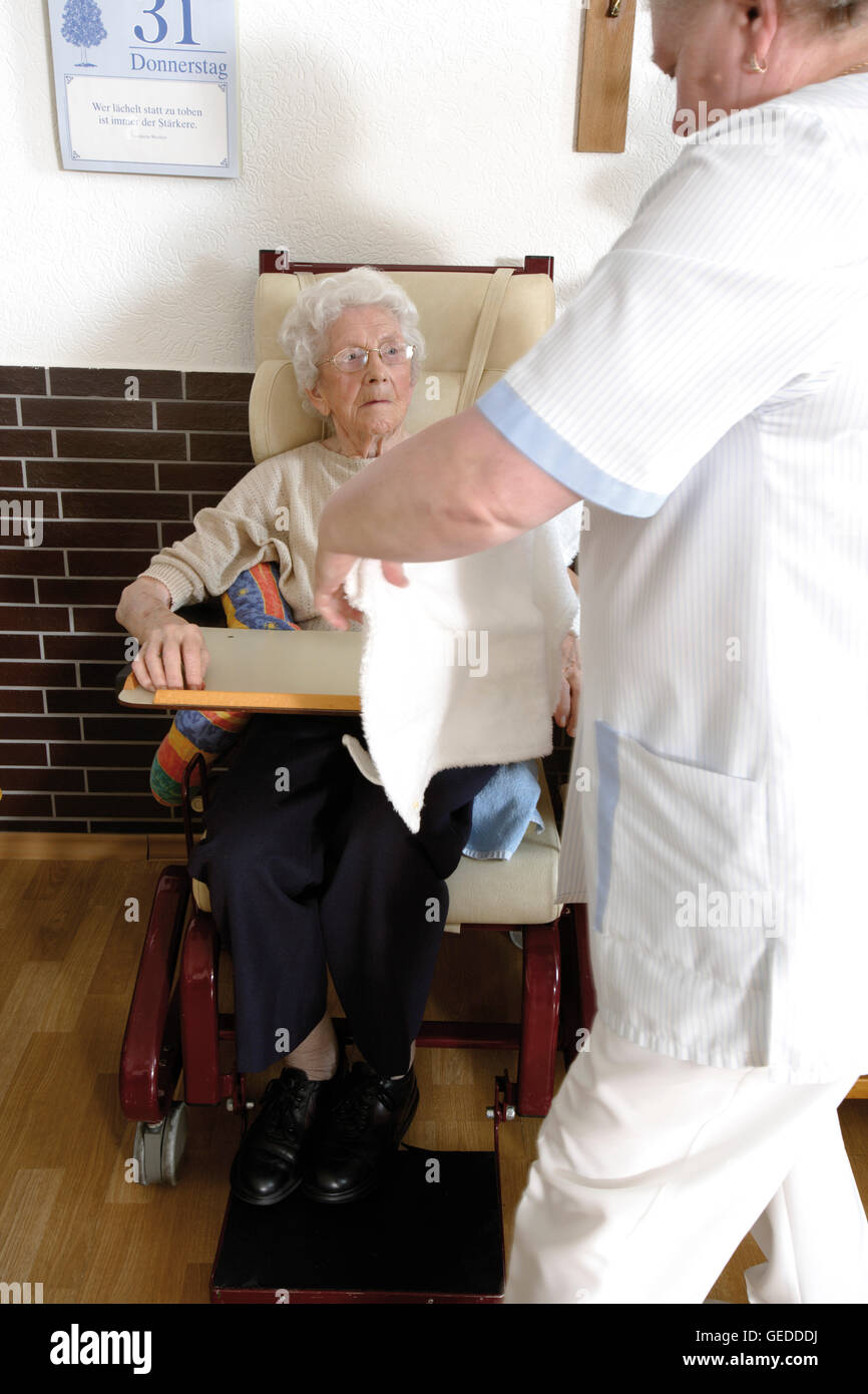 Pensioner sitting in a wheelchair at a nursing home Stock Photo