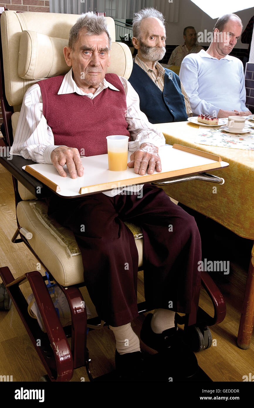Residents sitting in the dining hall of a nursing home Stock Photo