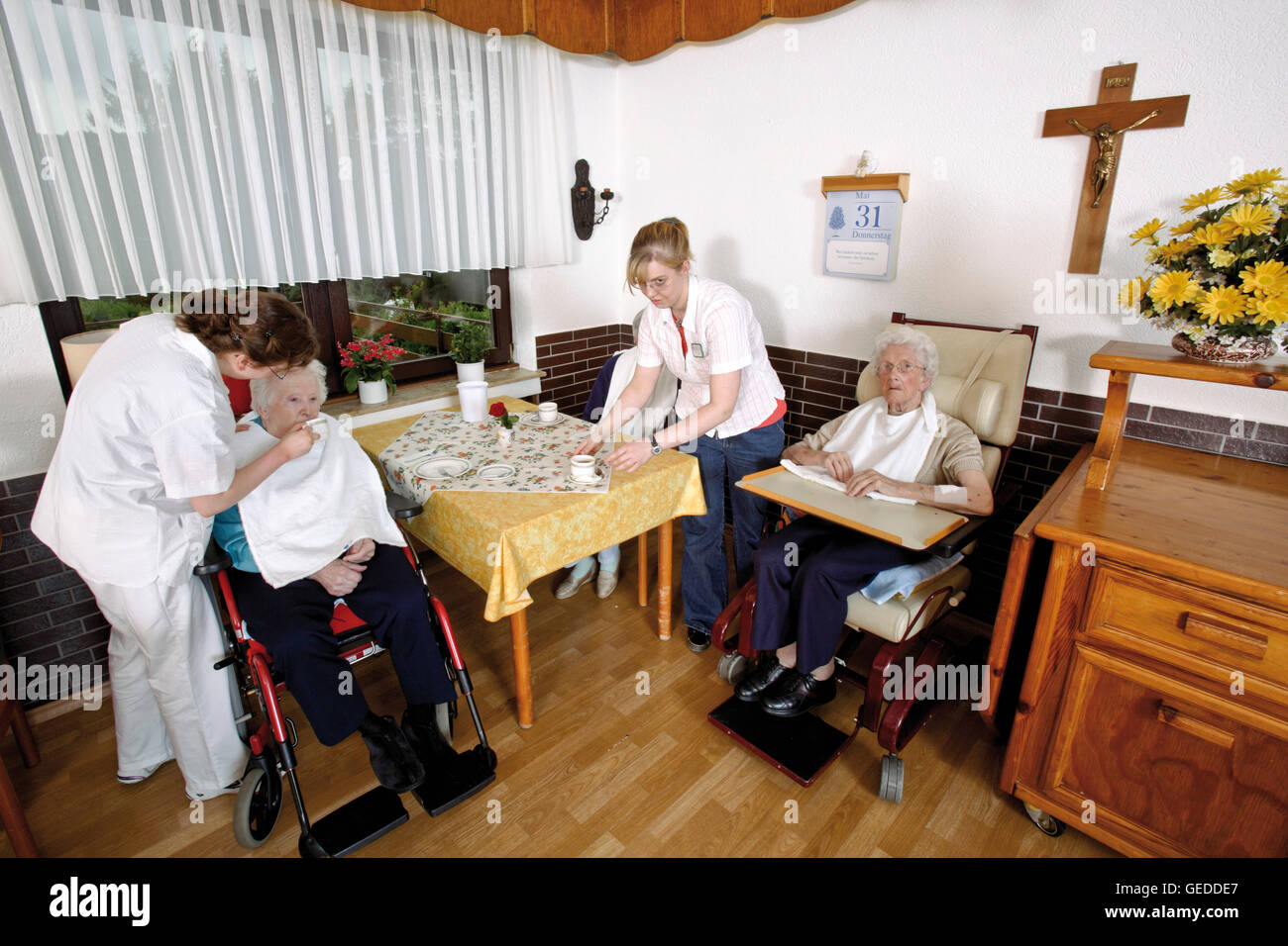 Nurses feeding residents of a nursing home Stock Photo