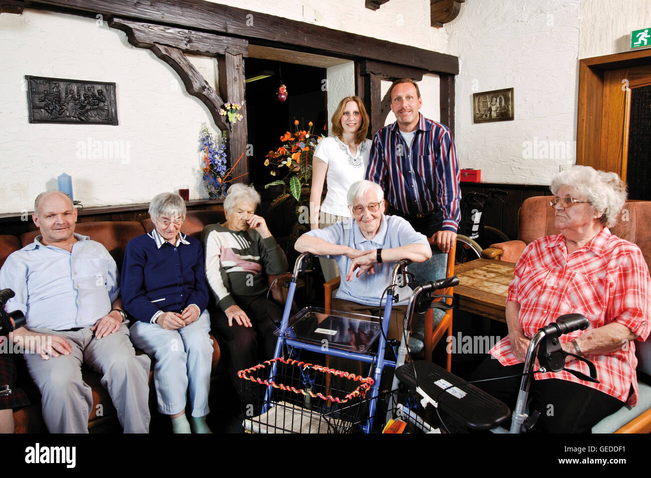 Residents and nursing staff in the common room of a nursing home Stock Photo