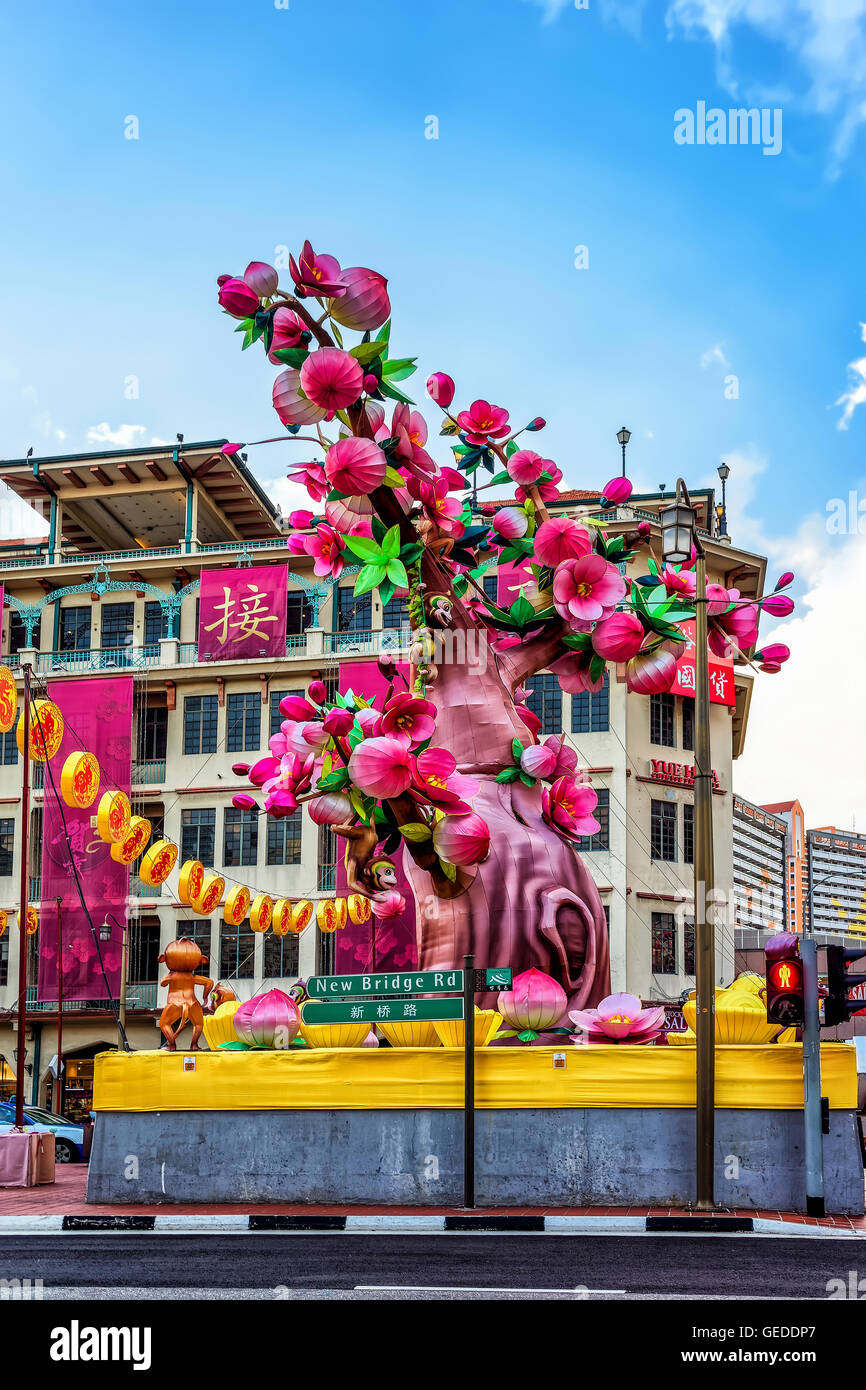 Singapore, Singapore - February 29, 2016: New Bridge Road street with Decoration for the Chinese New Year in Chinatown in Singapore. Tree with flowers and monkeys Stock Photo