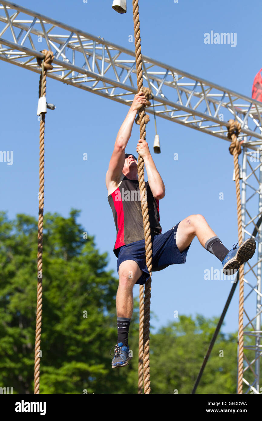 men climbing up rope intense exercise Stock Photo