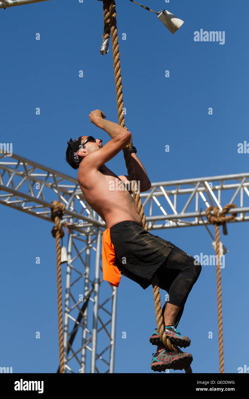 man climbing rope outdoor Stock Photo