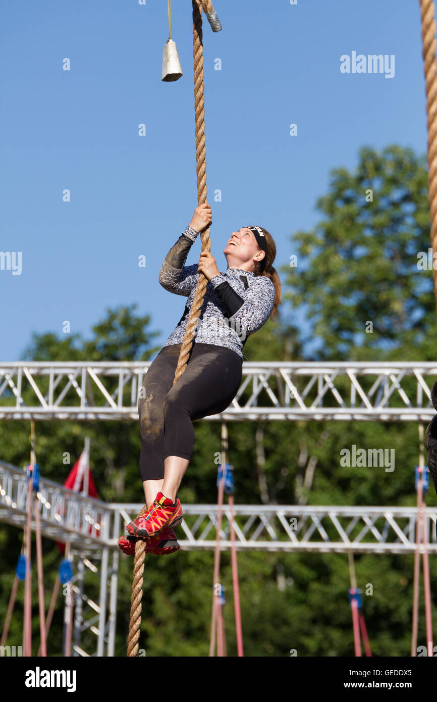 Side View Of A Young Caucasian Woman Hanging From A Horizontal Rope On A  Climbing Frame At An Outdoor Gym During A Bootcamp Training Session —  Outdoors, Workout Stock Photo #307087742