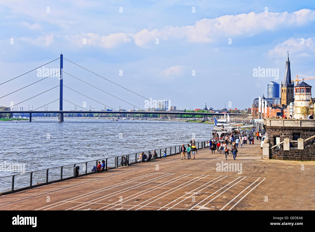 Dusseldorf, Germany - May 3, 2013: Rhine embankment promenade in the city center of Dusseldorf in Germany. Tourists nearby. It is the capital of Rhine Westphalia region. Stock Photo