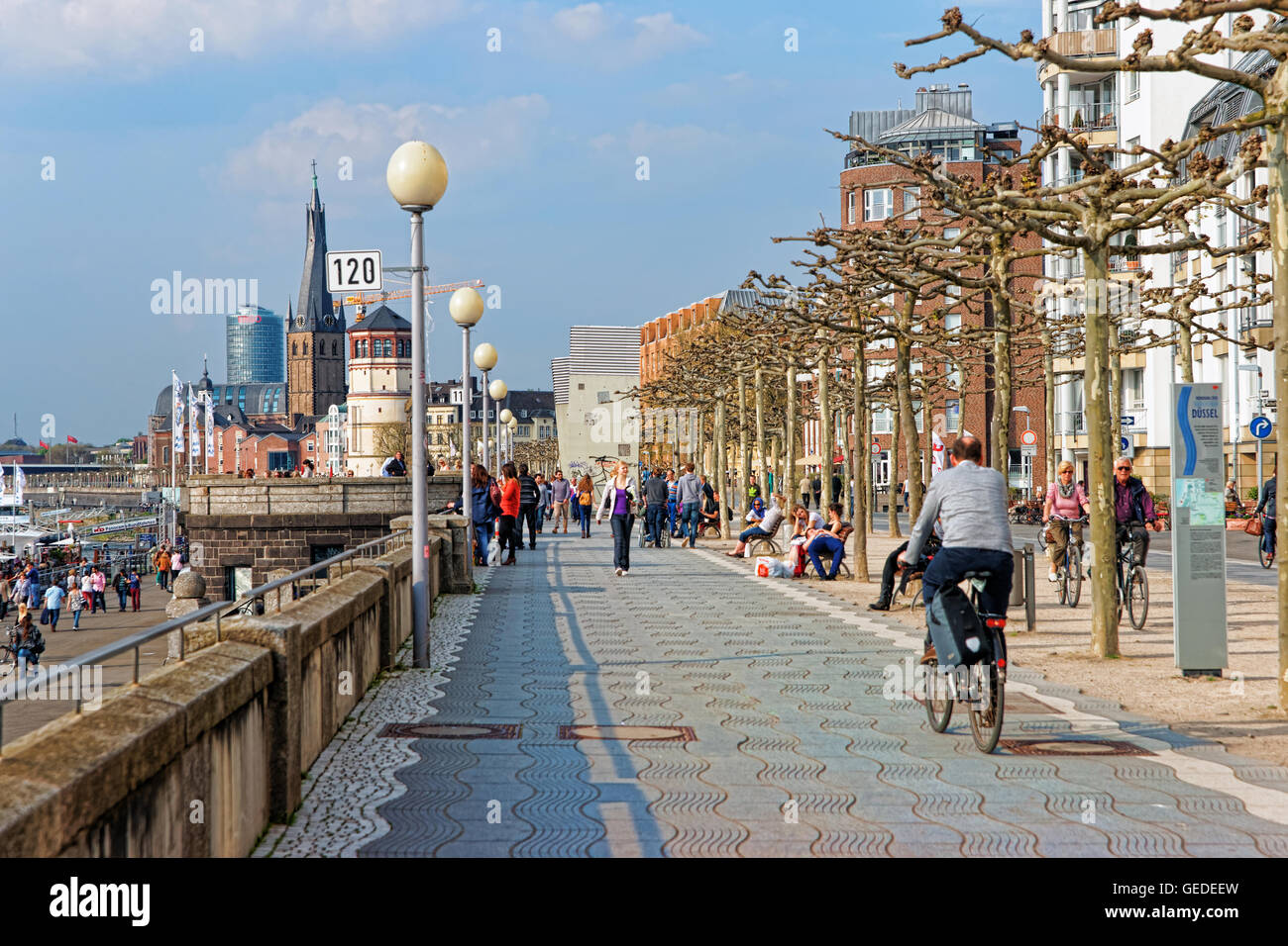 Dusseldorf, Germany - May 3, 2013: Rhine embankment promenade in the Old city center of Dusseldorf in Germany. Tourists nearby. It is the capital of Rhine Westphalia region. Stock Photo