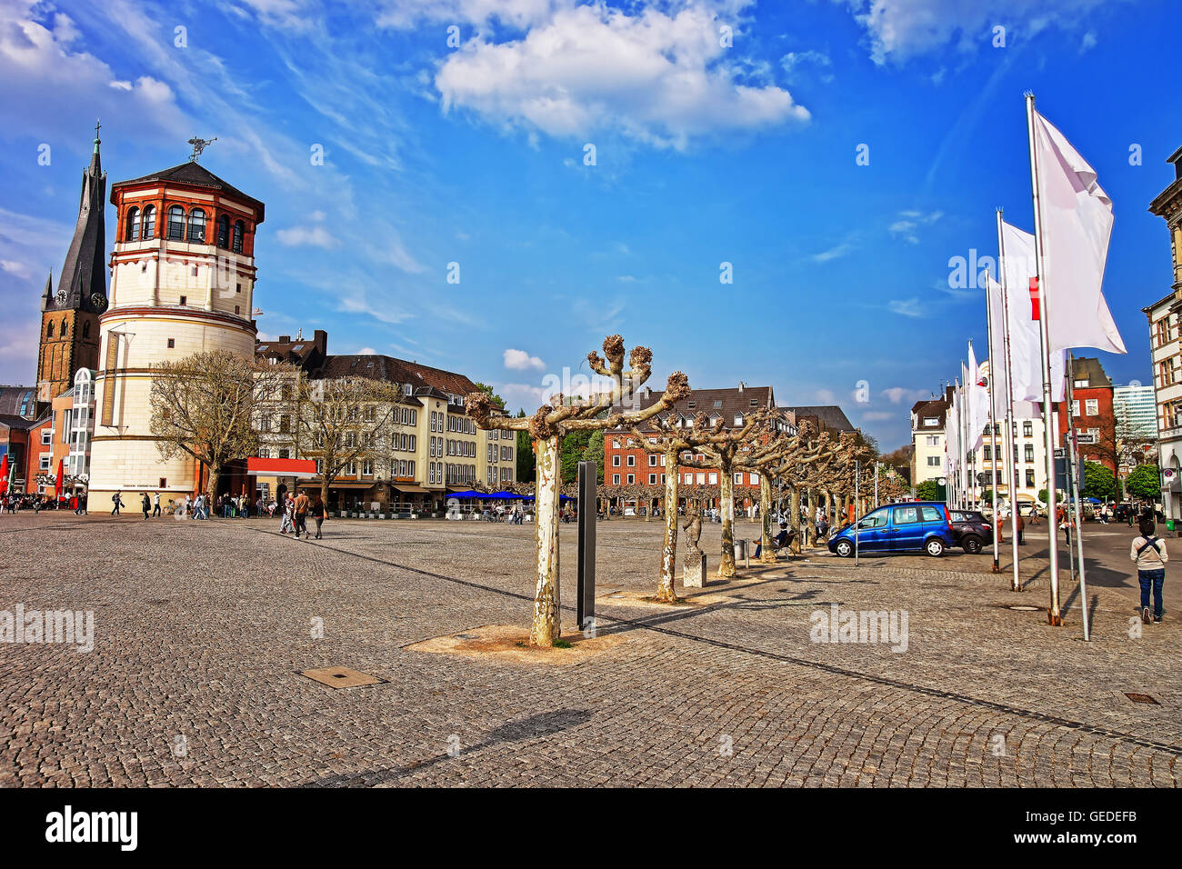 Dusseldorf, Germany - May 3, 2013: Housing and shipping museum and St Lambertus Basilica in the Old city center of Dusseldorf in Germany. Tourists nearby Stock Photo