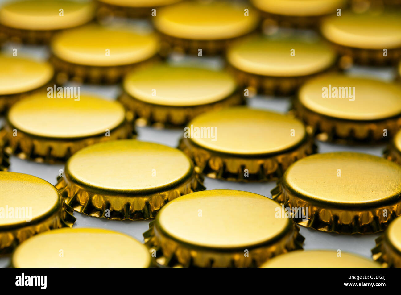 many yellow bottle caps on white background Stock Photo Alamy