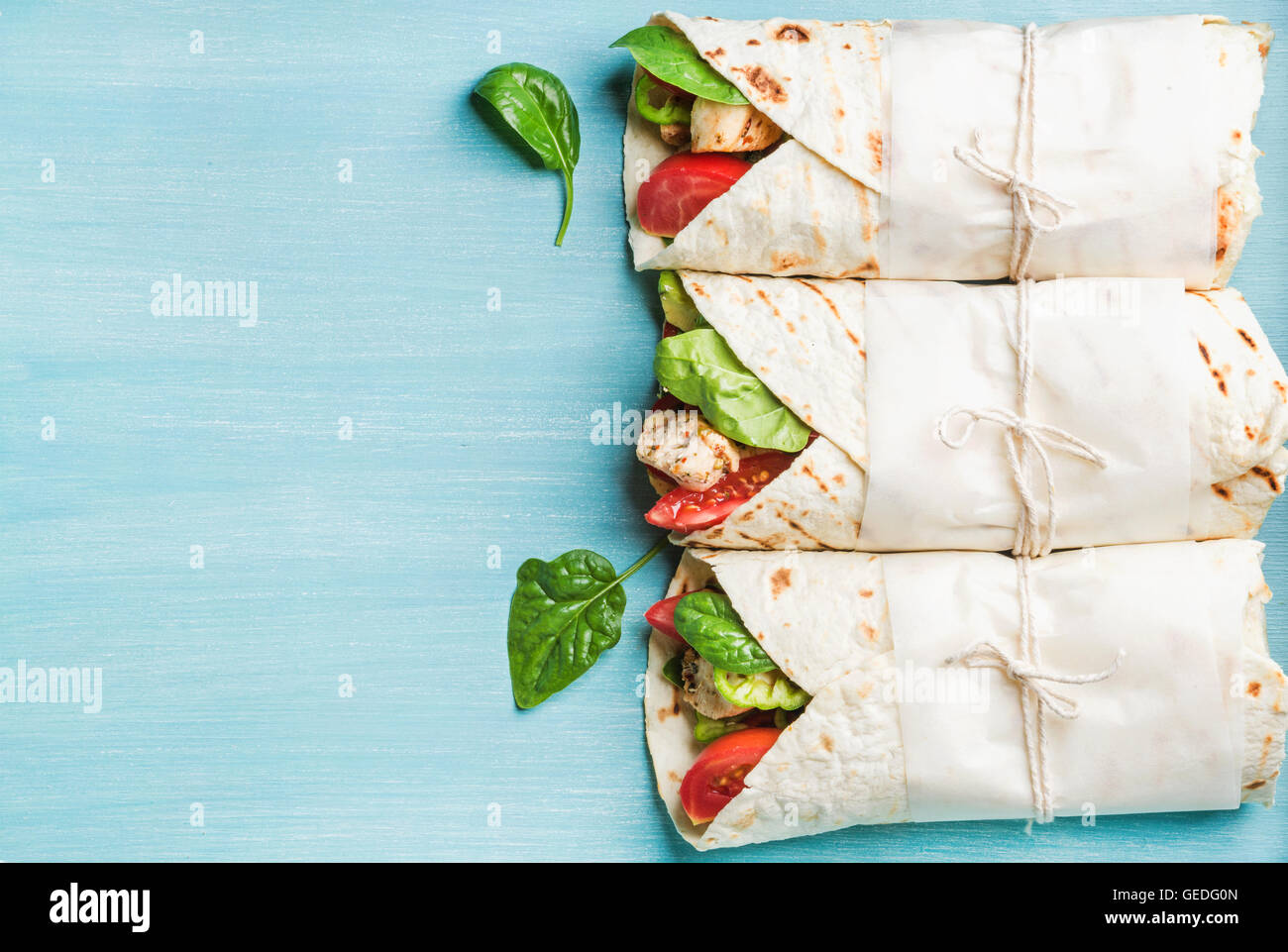 Healthy lunch snack. Three tortilla wraps with grilled chicken fillet