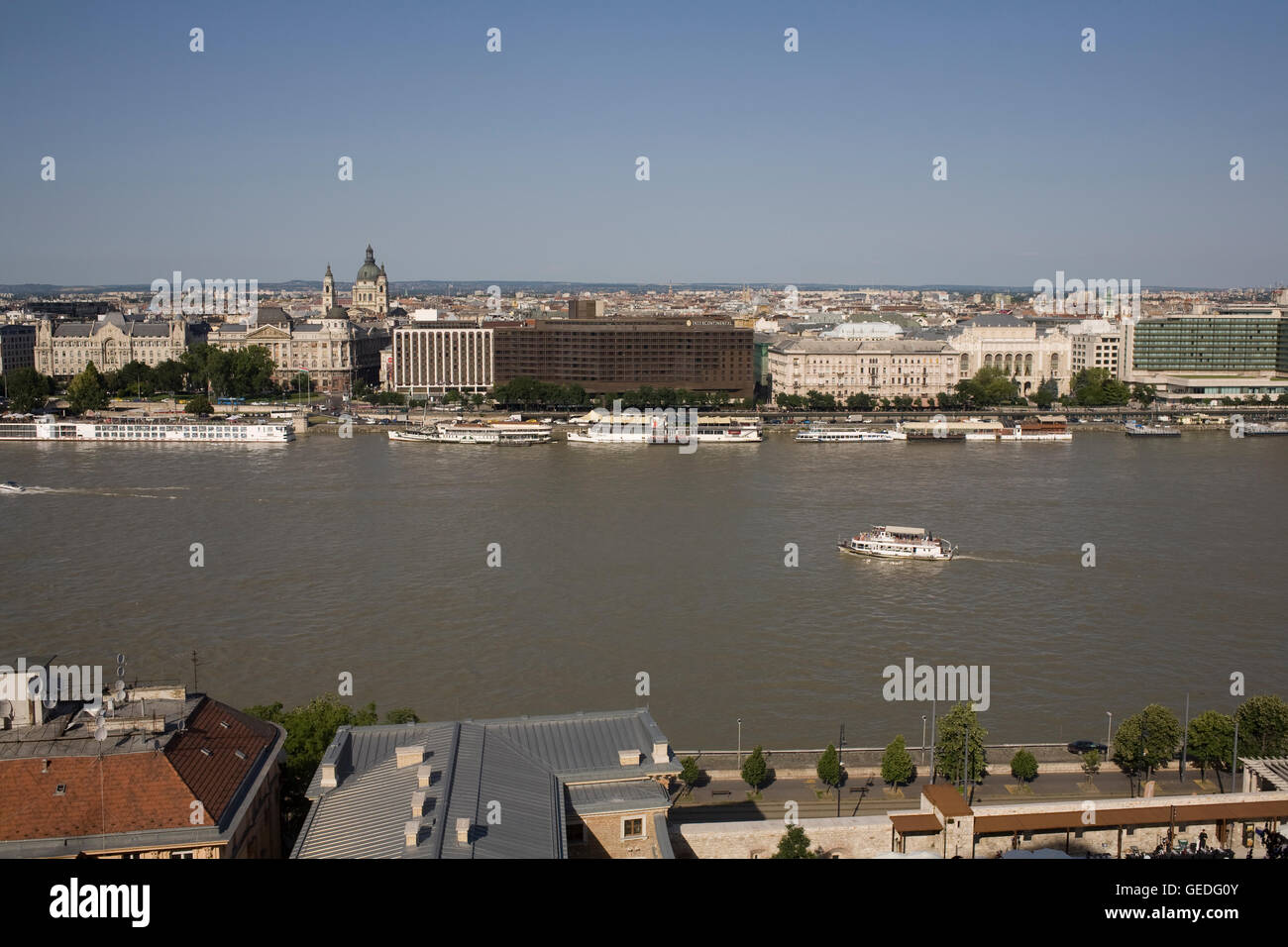 River Danube on warm summer afternoon seen from Buda side across to Intercontinental Hotel Stock Photo